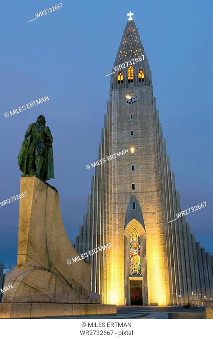 The Hallgrims Church with a statue of Leif Erikson in the foreground lit up at night, Reykjavik, Iceland, Polar Regions