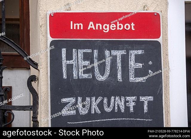 28 May 2021, Mecklenburg-Western Pomerania, Tribsees: A sign reading ""Today: Future"" hangs in Tribsees' Karl-Marx-Strasse