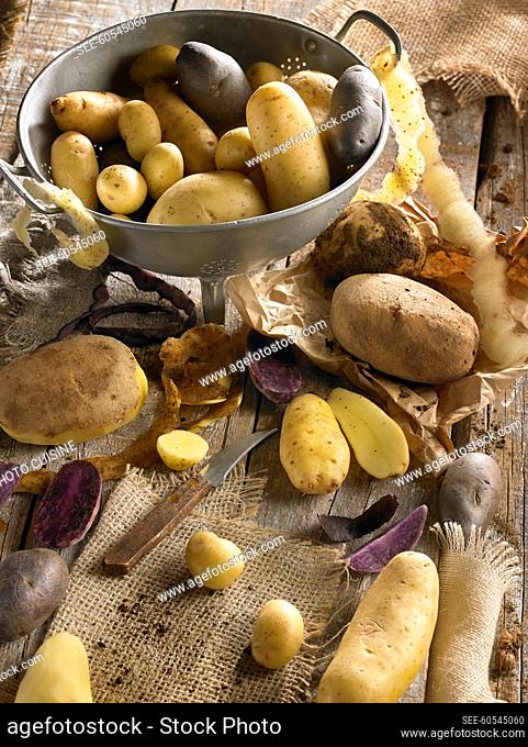 Different variety of potatoes and a colander