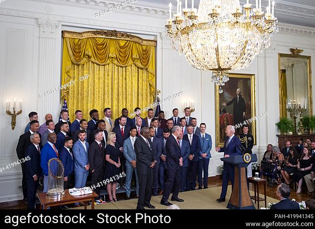 United States President Joe Biden, right, welcomes the Houston Astros to the East Room of the White House to honor their 2022 World Series victory