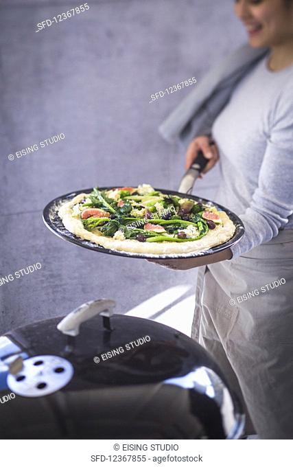 Pizza with rapini, figs, olives and blue cheese (unbaked)