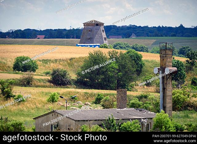 29 June 2020, Brandenburg, Angermünde/Ot Greiffenberg: A windmill without wings is located on a small hill just before entering the village