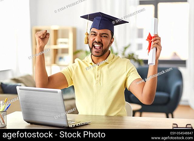 indian student with laptop and diploma at home