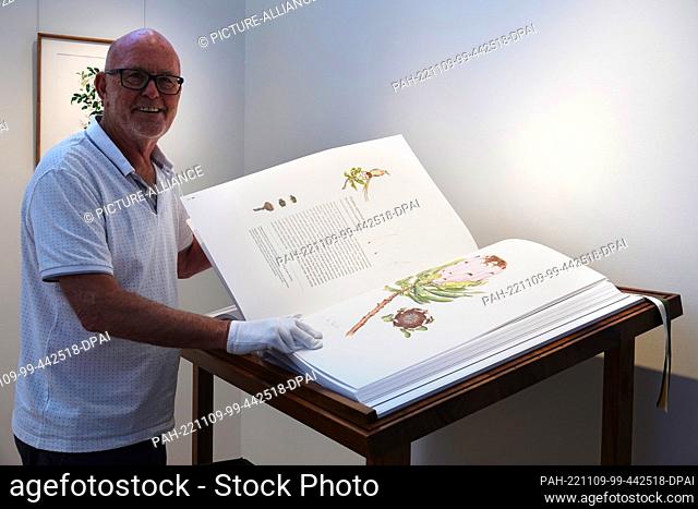 PRODUCTION - 20 October 2022, South Africa, Gansbaai: German Michael Lutzeyer shows art illustrations of rare, endangered or endemic plant species