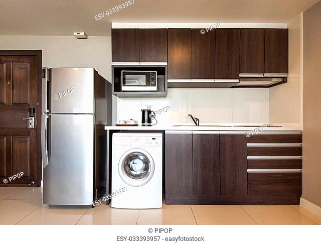 Kitchen with sink, refrigerator, Washer and microwave