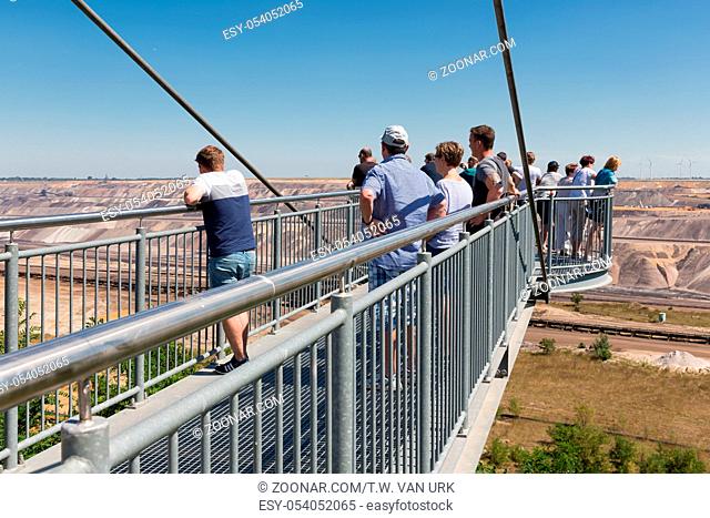 Garzweiler lignite mine, Germany - June 29 2018: People visiting viewpoint with skywalk at Garzweiler brown coal mine in Germany