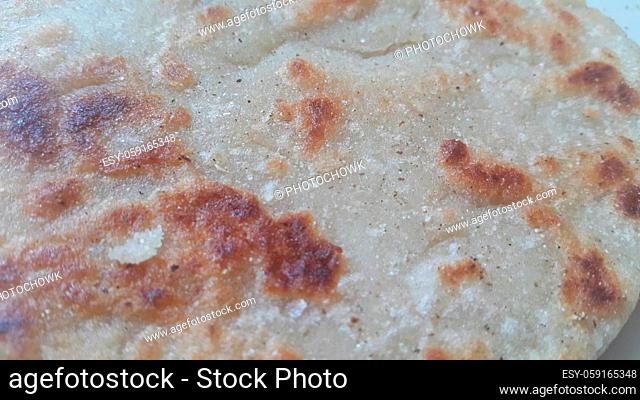 Closeup view of of traditional bread called Jawar roti or bhakri. Bhakri is a round flat unleavened bread often used in the cuisine of many Asian countries
