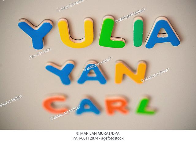 ILLUSTRATION - The first names Yulia, Carl and Yan spelt out of magnet letters are sticking to a metal wall in Stuttgart, Germany, 15 July 2015
