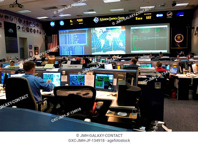 Overall view of the space shuttle flight control room in Johnson Space Center's Mission Control Center as flight controllers support the docking of the...