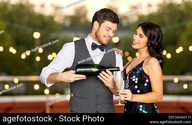 happy couple with champagne and glass at party