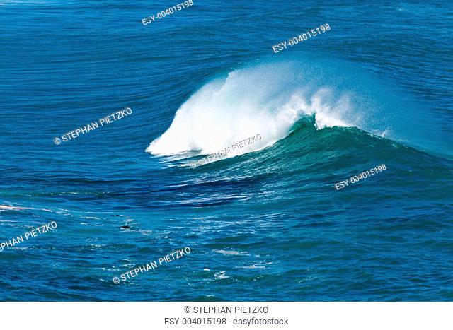 Turbulent water of breaking ocean wave and spray