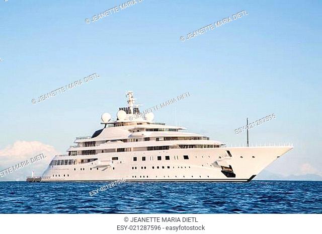 Gigantic big and large luxury mega or super motor yacht on the ocean
