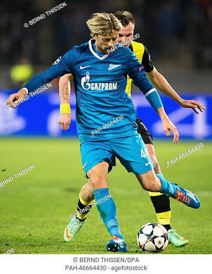 Dortmund's Kevin Großkreutz (back) vies for the Ball with Zenit's Anatoliy Tymoshchuk during the UEFA Champions League round of 16