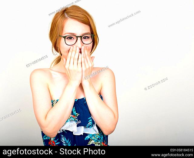 Studio shot of young beautiful Japanese woman against white background