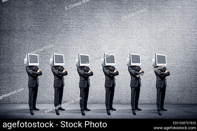Businessmen in suits with monitors instead of their heads keeping arms crossed while standing in a row in empty