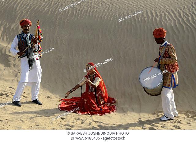 Folk musicians on sand dune in Jaisalmer at Rajasthan India MR#704
