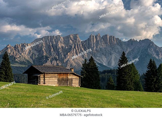 Carezza, Dolomites, South Tyrol, Italy, Mountain Hut in the pastures of Colbleggio, In the background the peaks of the Latemar