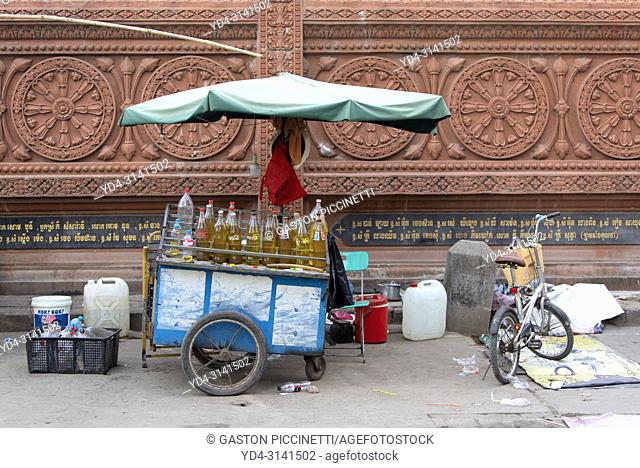 Small street gas station, this is where people buy gas for their motorcycles. The bottles are filled by hand one by one from a main tank and then sold to the...