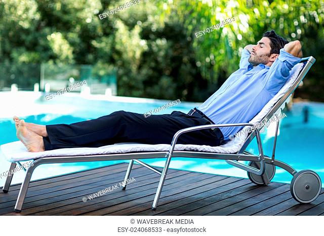 Smart man relaxing on sunlounger