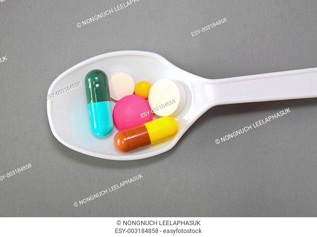 A spoonful of Pills and capsules