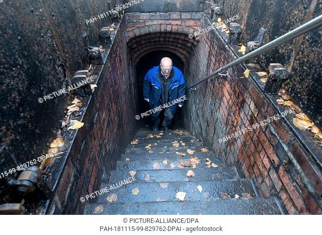 14 November 2018, Bavaria, München: The former employee of the Munich city drainage Ben Tax climbs the stairs at an entrance to the sewage system dating from...