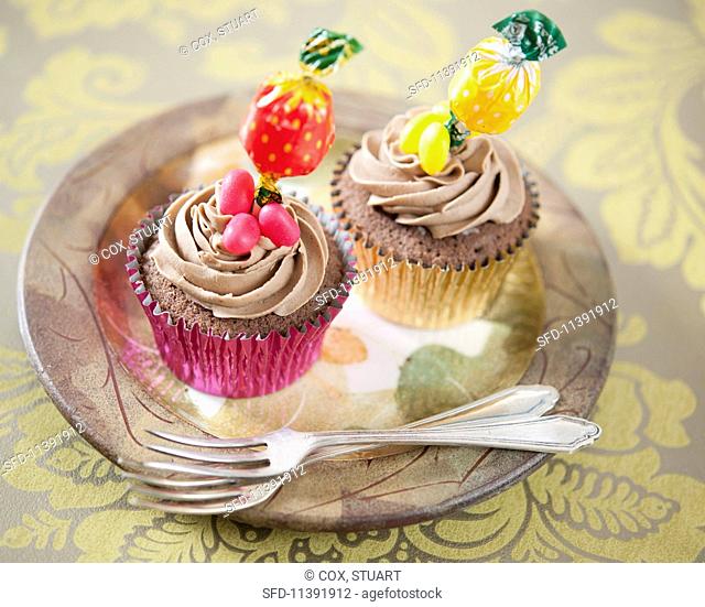 Chocolate cupcakes decorated with lollipops and jelly beans