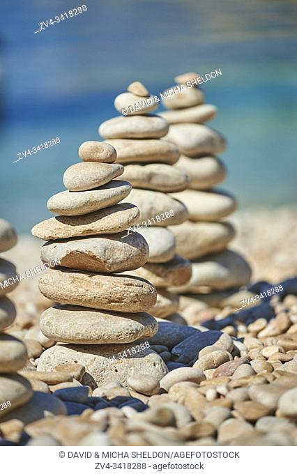 Stacked stones at the coast of the sea, Cres, Croatia, Europe