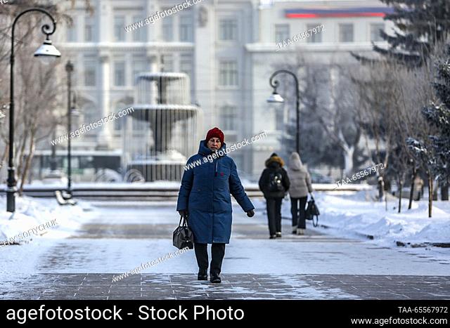 RUSSIA, OMSK - DECEMBER 8, 2023: A woman walks in a street in the Siberian city of Omsk on a frosty winter day. According to Russia's weather forecasting agency