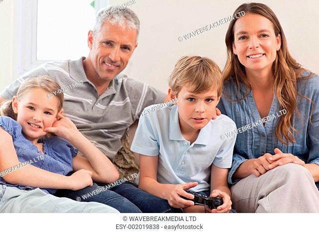 Family playing video games in living room