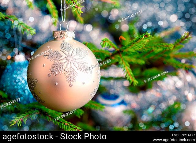 Christmas celebration holiday background - christmas-tree decoration bauble on decorated Christmas tree with defocused blurred lights bokeh and copyspalce