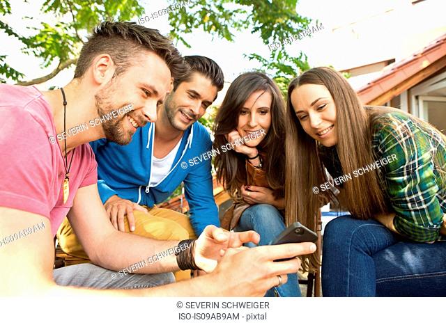 Four friends with cell phone