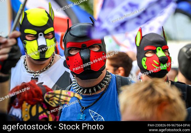 26 August 2023, Bremen: Participants of the Christopher Street Day (CSD) wear dog masks in Bremen. The police expected 10, 000 to 12