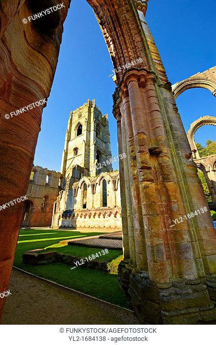 Gothic arch & bell tower of Fountains Abbey , founded in 1132, is one of the largest and best preserved ruined Cistercian monasteries in England  The ruined...