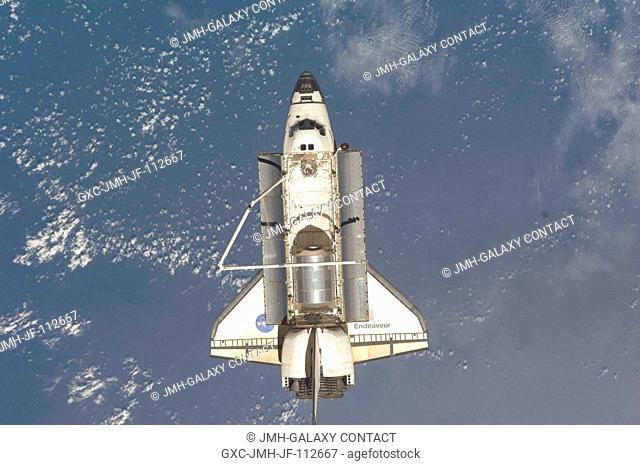 Backdropped by a blue and white Earth, Space Shuttle Endeavour is featured in this image photographed by an Expedition 18 crewmember after the shuttle undocked...
