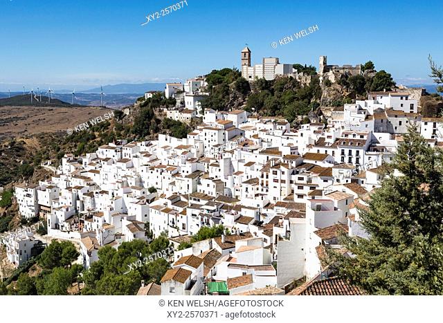 Casares, Malaga Province, Andalusia, southern Spain. View across village to the remains of the Arab castle and church, the Iglesia de la Encarnación