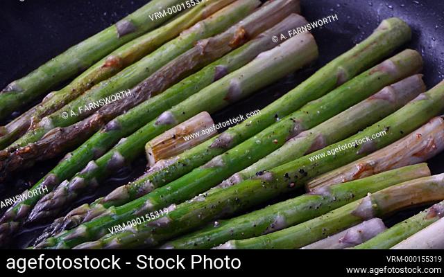 Asparagus frying in a pan
