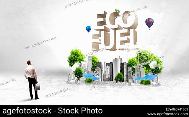 Rear view of a businessman standing in front of ECO FUEL inscription, Environmental protection concept