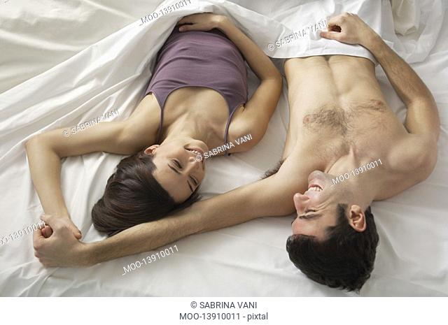 Couple lying in bed view from above