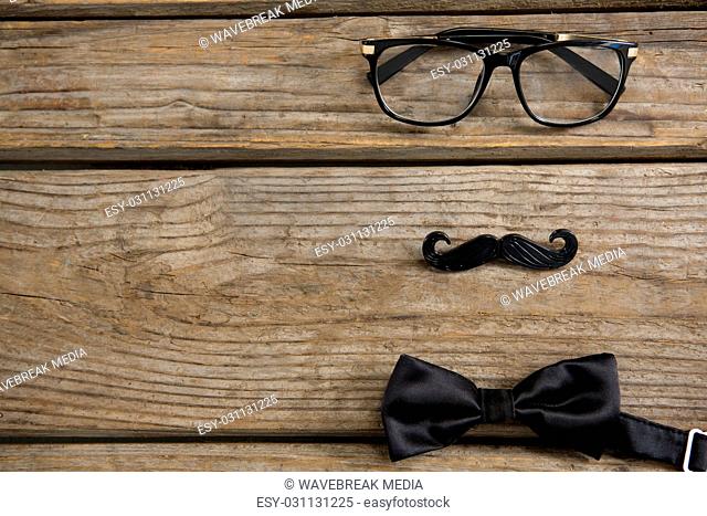 High angle view of anthropomorphic face made with eyeglasses and bow tie