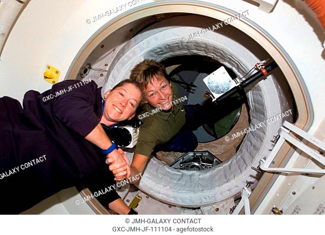 Astronaut Peggy Whitson (right), Expedition 16 commander, greets astronaut Pam Melroy, STS-120 commander, after hatch opening between the International Space...