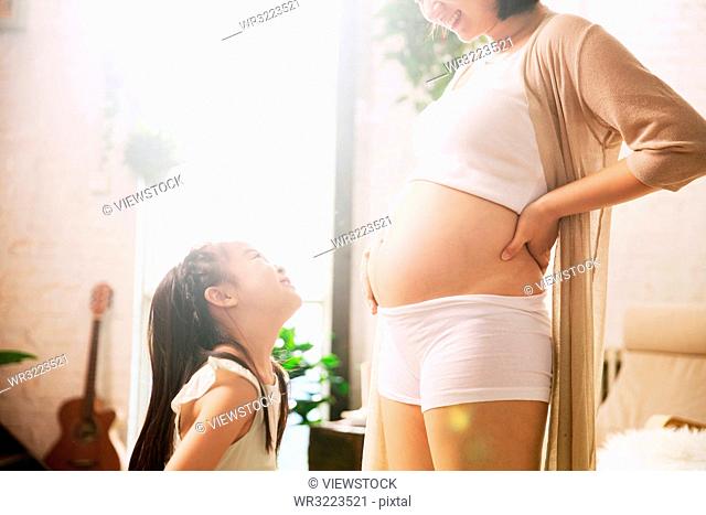 The pregnant mother and the little girl