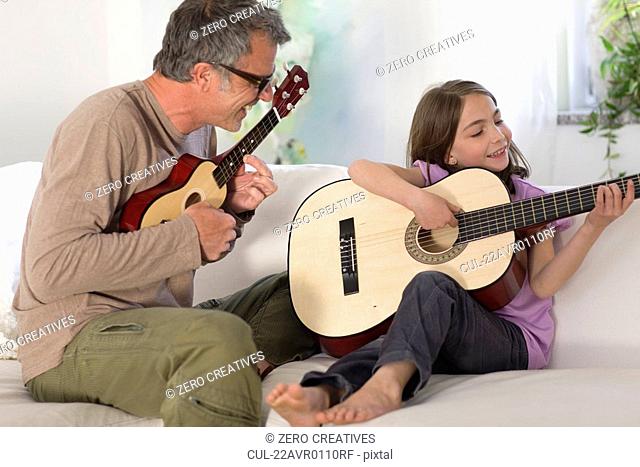 Father and daughter making music