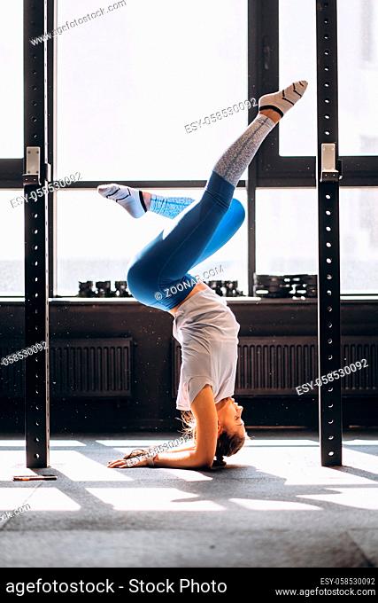 Young woman doing yoga or pilates exercise