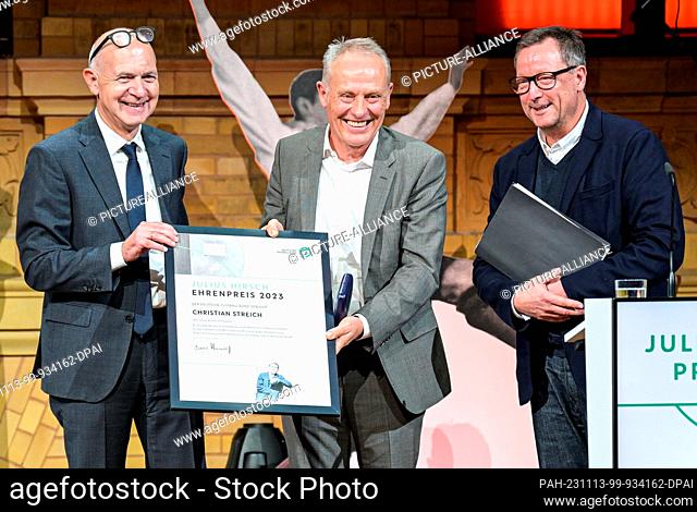 13 November 2023, Berlin: Julian Streich (M), soccer coach of SC Freiburg, receives the honorary award from DFB President Bernd Neuendorf (l)