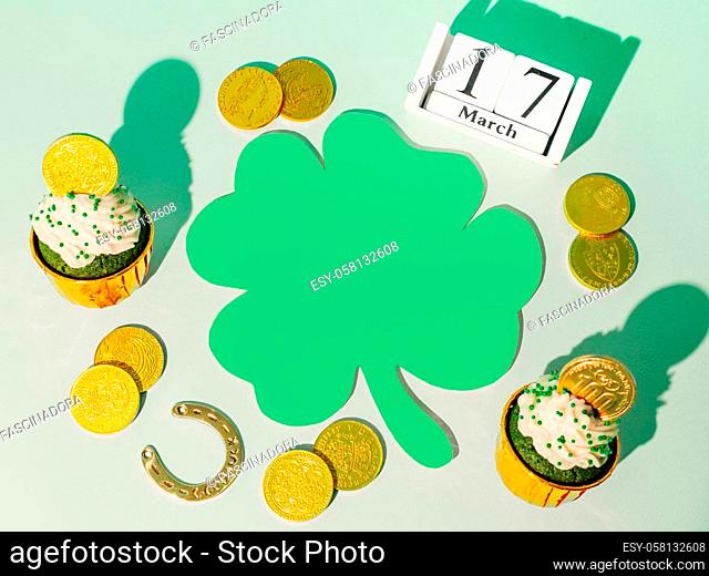 St.Patrick's day with lucky symbols. Top view of Saint Patrick's day holiday with green paper clover or shamrock leaf. Flat lay. Copy space