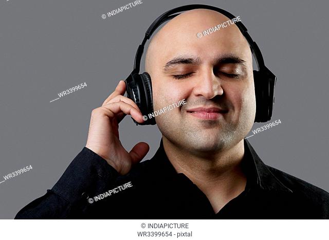 Bald man listening to music