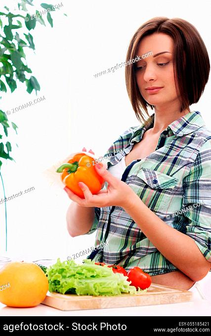 Happy woman preparing a healthy salad at home
