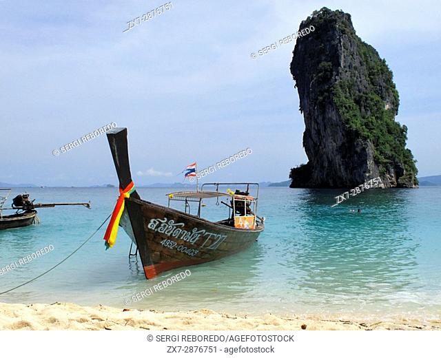 Long-tail boat moored on the beach at Koh Poda Islands in the Andaman Sea, Thailand. Ko Poda is an island off the west coast of Thailand, in Krabi Province