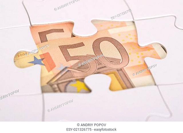 Euro Banknote Hidden Under Jigsaw