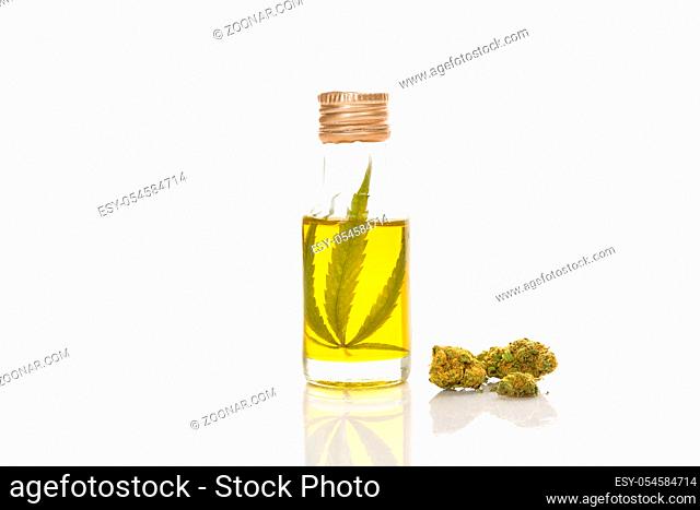 CBD marijuana oil extract with marijuana buds, isolated on white background